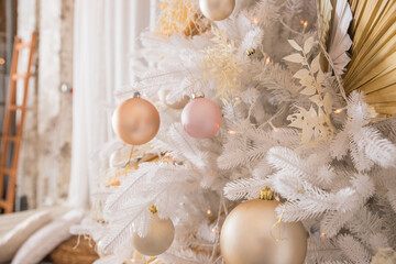 Fototapeta na wymiar White Christmas tree with pastel colored decoration with balls on fir branches with blurred background.Holiday decoration.Christmas and New Year holidays background