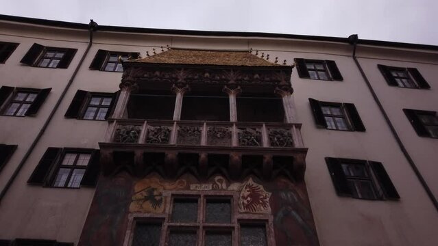 Innsbruck, Austria, December 7, 2022: TILT SHOT - The Goldenes Dachl (Golden Roof), ornamented with 2,738 fire-gilded copper tiles, in the Old Town (Altstadt) section of Innsbruck. 
