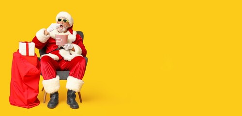Santa Claus with popcorn watching Christmas movie against yellow background with space for text