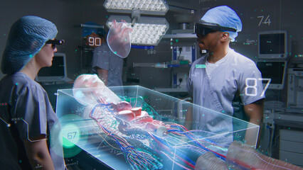 Diverse surgeons in AR headsets work in operating room using futuristic holographic display. 3D graphics of virtual human skeleton and organs. Technology of AI-assisted surgery. High-tech medicine.