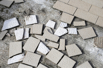 Cracked brown tiles on cement floor