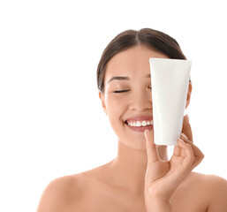 Beautiful Asian woman with tube of cream on white background, closeup