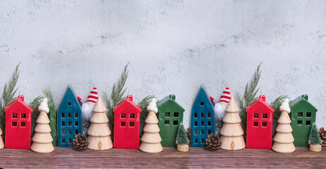 Christmas decoration with wooden small houses and pine trees in Scandinavian style 