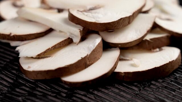 Sliced brown edible portobello champignon mushrooms. Italian cuisine fresh ingredient close up. Rotation