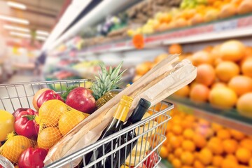 full of groceries shopping cart in store