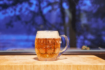 Famous czech lager beer pilsner type served in  festive mug made from bohemian crystal glass in...