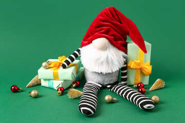 Christmas gnome with gift boxes and decorations on green background