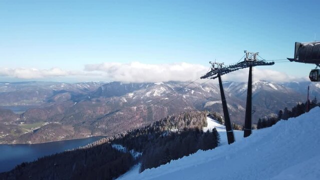DOLLY SHOT - The Cabine Zwolferhorn cable car. Cable car or telecabin in Sankt St. Gilgen village, starting from the town and up to Das Zwolfer station, Austria.