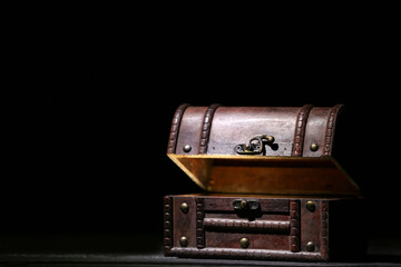 Old chest with treasures on black background