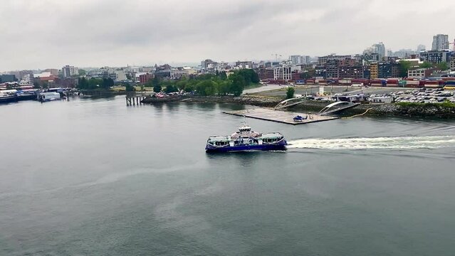The SeaBus is a passenger-only ferry service in Metro Vancouver, British Columbia, Canada. Sailing from Waterfront station in Vancouver on a rainy day. Helijet International helicopter airline. 