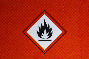 Flammable sign on the red paper. Flammable materials sign