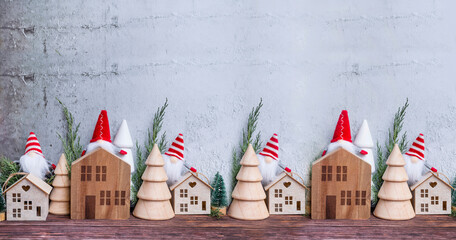 Christmas decoration with wooden small houses and pine trees in Scandinavian style 