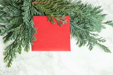 Fototapeta na wymiar red Christmas card on green fir branches