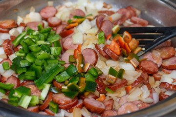 Close-up of the texture of the ingredients. Vegetables with vivid colors. preparation of a dish with vegetables, chopped vegetables in a pan, ingredients for Stew with peppers and sausage, 