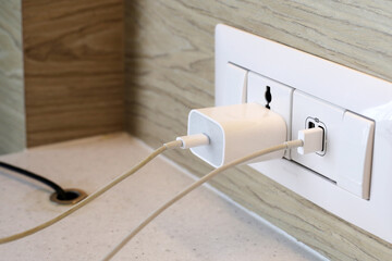 Electrical power socket, Phone plugged in on socket wall - obrazy, fototapety, plakaty