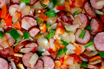 Close-up of the texture of the ingredients. Vegetables with vivid colors. preparation of a dish with vegetables, chopped vegetables in a pan, ingredients for Stew with peppers and sausage, 