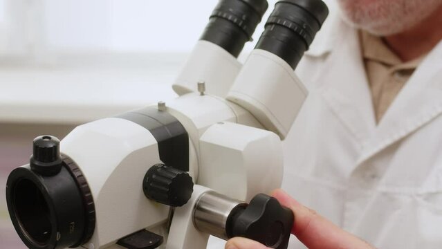 Doctor Gynecologist examining patient on chair with gynecological equipment. Colposcopy, examination of a cervical cancer. Colposcope close-up. Maternity fertility IVF issues. Abortion and ovulation