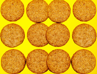 background with cookies a lot of cookies on a yellow background,cookies flat lay image isolated on yellow colour background with copy space