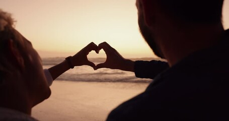 Couple, heart and hands at beach in sunset for love, care and romantic holiday, vacation and date from the back. Man, woman and finger shape at sea in silhouette for support, freedom and emoji sign - Powered by Adobe