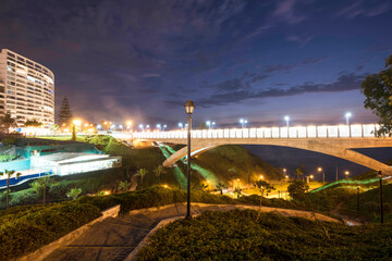 PERU Panoramic view of the Villena Rey Bridge of the Miraflores district with luxurious apartments and Pacific Ocean at night © Luis