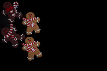 Christmas gingerbreads on a black backgroundChristmas cookies on a black background,Christmas gingerbread cookies,Christmas cookies,background with Christmas cookies The christmas pattern