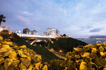 PERU Panoramic view of the Villena Rey Bridge of the Miraflores district with luxurious apartments and Pacific Ocean at night © Luis