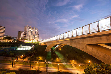 PERU Panoramic view of the Villena Rey Bridge of the Miraflores district with luxurious apartments and Pacific Ocean at night © Luis