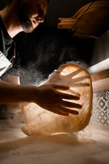 Expertise on display. Chef pizza dough tossing technique.