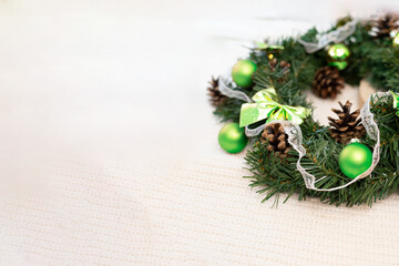 Holiday decoration - wreath crafted from twigs, with tasteful green ornaments, composition allowing...