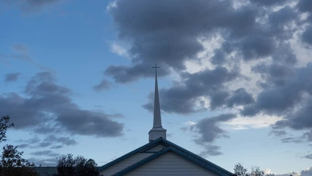 Time lapse of clouds above a church steeple