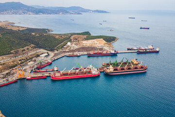 Commercial cargo bulk terminal with cargo vessels of industrial port international trade and logistic. Aerial view