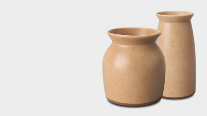 Closeup of earthenware ceramic jars, isolated on grey copy-space background.
