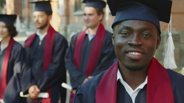 Close up portrait of proud African American student looking at camera during ceremony of graduation