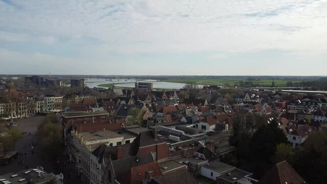Flying over the Dutch old town Deventer rooftops towards the banks of the river IJssel.