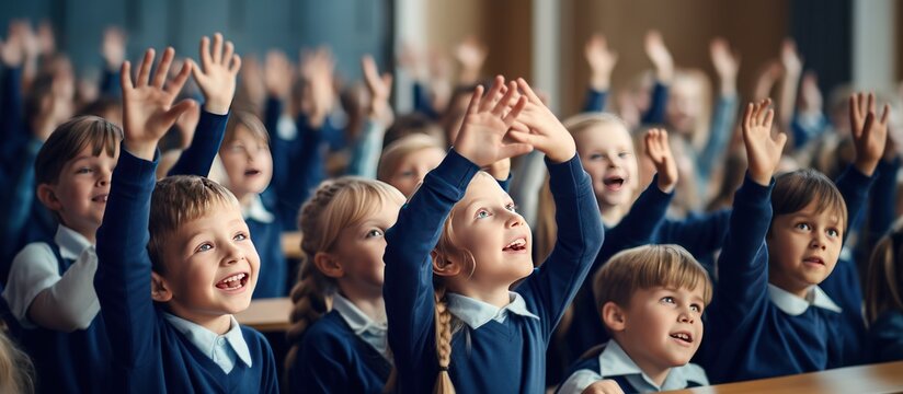Group happy of student or children wearing blue uniforms raising hands in classroom