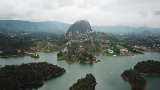 Aerial drone footage of El Penon de Guatape near Medellin in Antioquia, Colombia. Large and unique alone rock with stairs to the top, touristic place. Big stone in Colombia. High quality 4k footage.