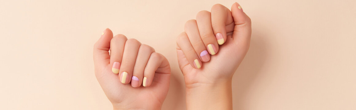 Fashionable minimal spring summer nail design. Beautiful yellow lavender manicure on begie background