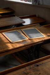 Blank Wooden Slates on Double School Desk Lit By Window Light