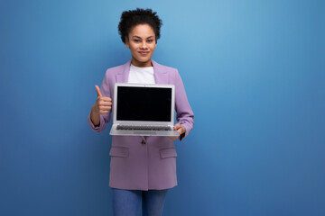 young positive successful latin business woman with ponytail hairstyle dressed in jacket holding laptop