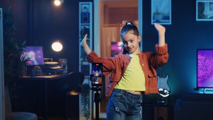 Kid doing viral dance choreography in living room with 3D rendered animations on computer screens...