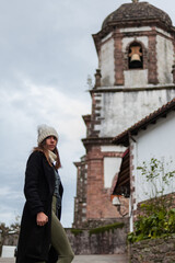 Young woman tours rural Zugarramurdi.