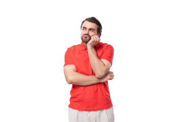 a young smart 35 year old european man with a styled haircut and a beard dressed in a red t-shirt...