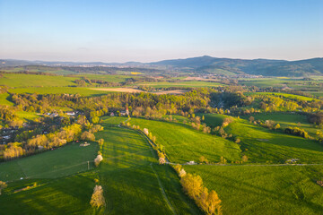Green rural landscape around Liberec with Jested mountain ridge on background. Sunny summer evening, Czechia