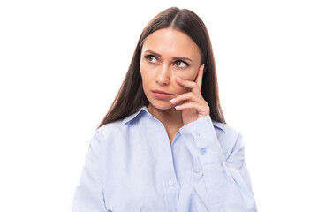 portrait of a young caucasian model woman with light makeup and dark straight hair dressed in a blue blouse on a white background with copy space