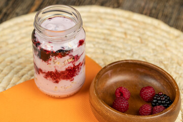 a glass jar with sweet delicious yogurt yams and muesli