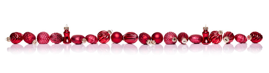 Red Christmas balls in a row side by side on white background, Xmas border
