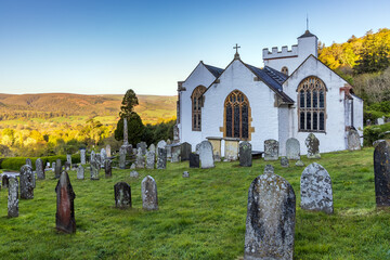 The pretty whitewashed church of All Saints in Selworthy, Exmoor National Park, Somerset. - obrazy, fototapety, plakaty