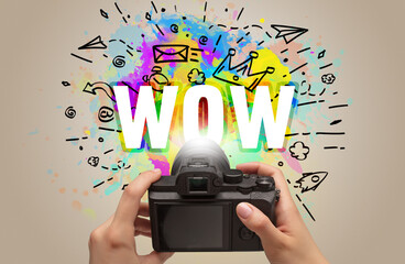 Close-up of a hand holding digital camera with abstract drawing