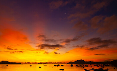 Beautiful colorful sunset or sunrise sky over sea with dramatic clouds nature environment background