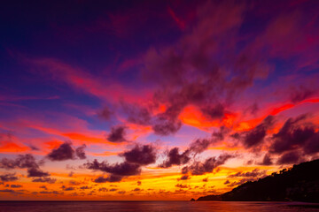 Beautiful colorful sunset or sunrise sky over sea with dramatic clouds nature environment background